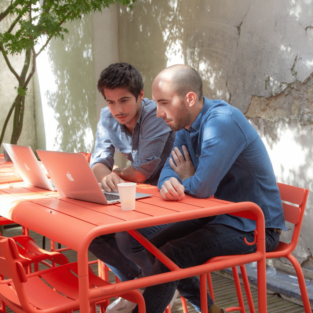 Deux personnes regardent un ordinateur et travaillent sur un référentiel de compétences